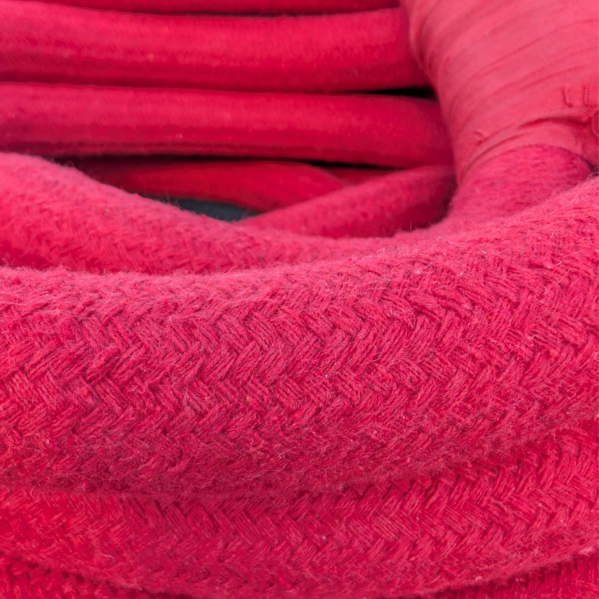 Close-up of the braided cotton cover on a red Aerial Obsessed corde lisse aerial rope