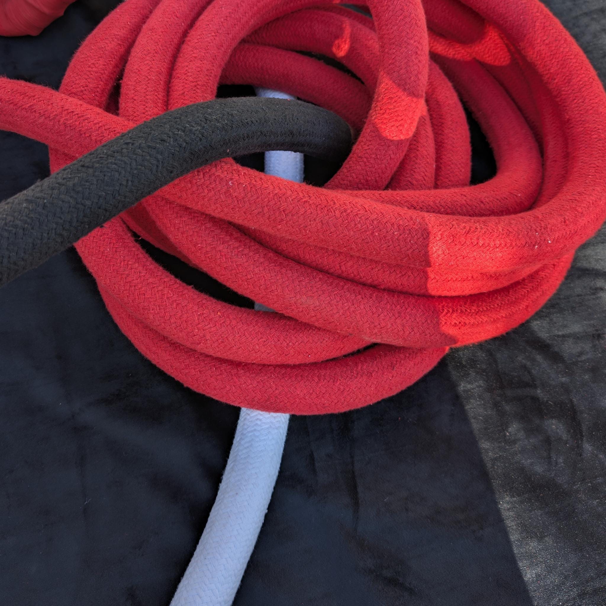 Black and red corde lisse aerial ropes coiled together, 32 mm diameter