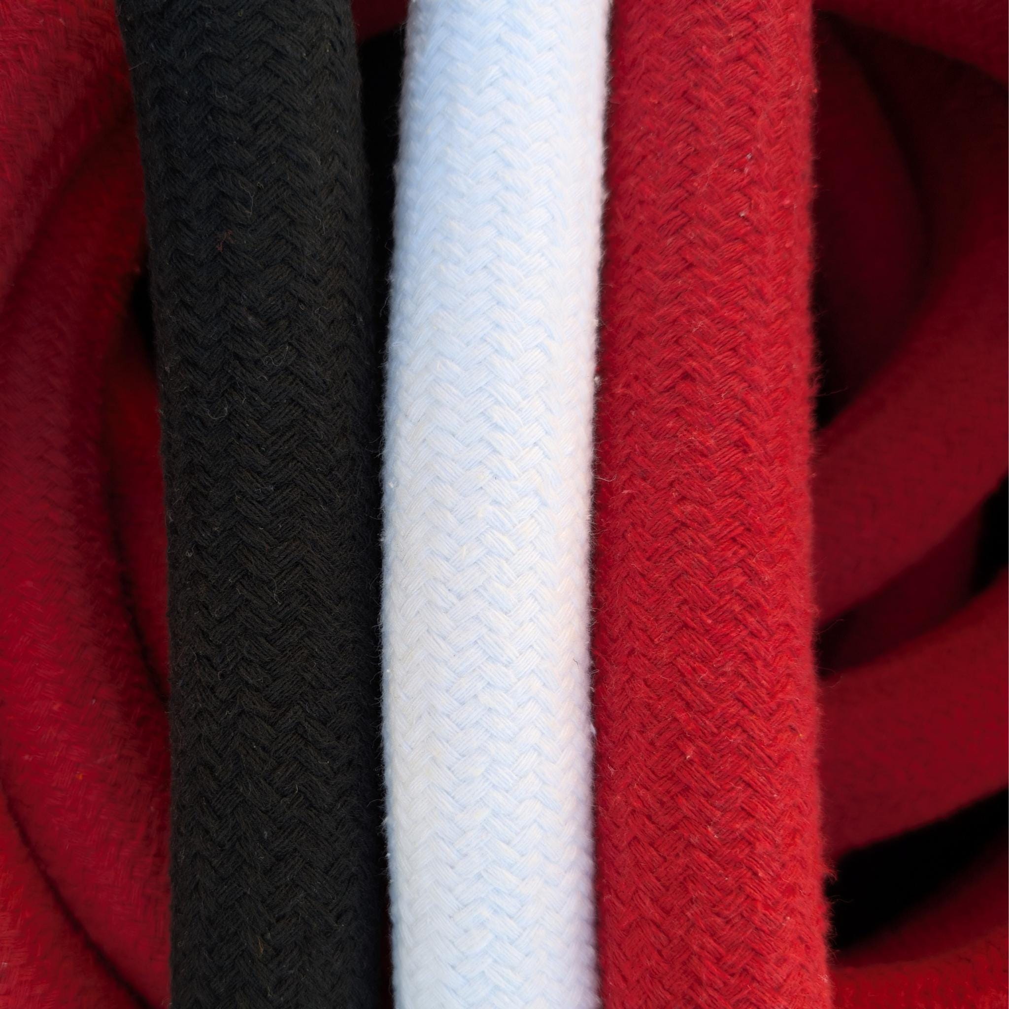 The three colour options for Aerial Obsessed corde lisse rope side by side: black, white and red