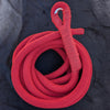 Red corde lisse aerial rope by Aerial Obsessed, coiled, with the spliced eye and thimble at the top